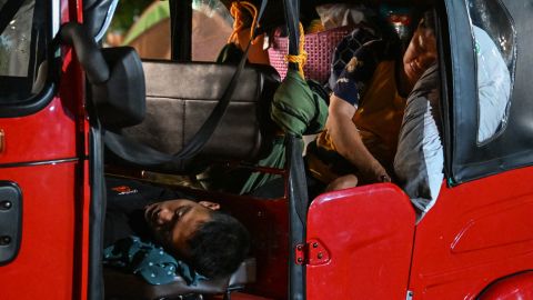 People sleep in a tricycle in Mati City after two powerful quakes struck off the southern Philippines, on Friday.