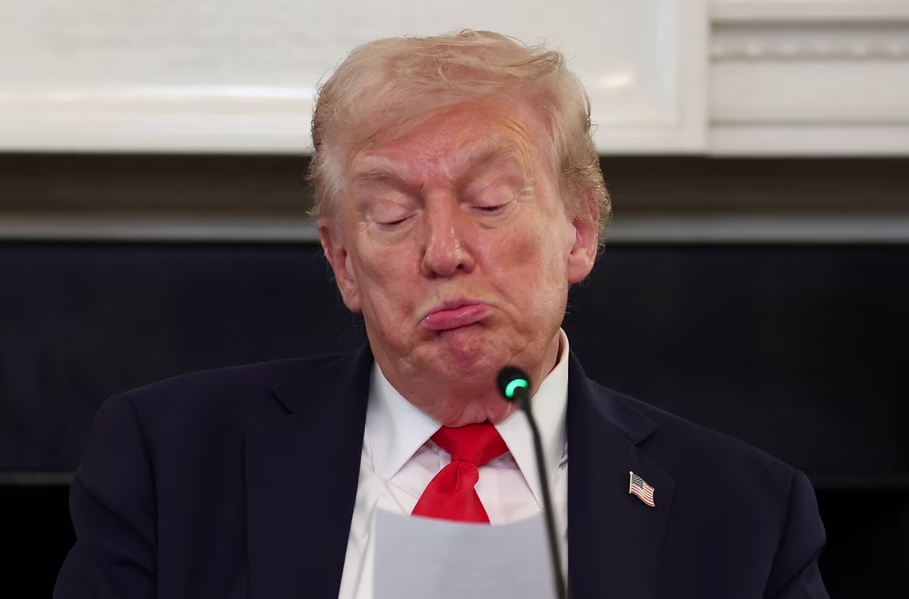 Donald Trump reads a note handed to him by Marco Rubio he said was regarding Middle East peace talks during a roundtable discussion in the State Dining Room of the White House yesterday.