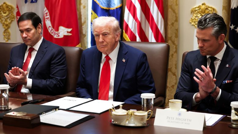 Secretary of State Marco Rubio and Defense Secretary Pete Hegseth clap for President Donald Trump during a Cabinet meeting at the White House on Thursday.