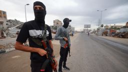 Members of the internal security forces loyal to the Palestinian group Hamas, man a checkpoint in the Nuseirat refugee camp in the central Gaza Strip, on October 12, 2025. Israel declared a ceasefire in Gaza and began to pull back its forces on October 10, as tens of thousands of exhausted Palestinians made their way back to their devastated homes.