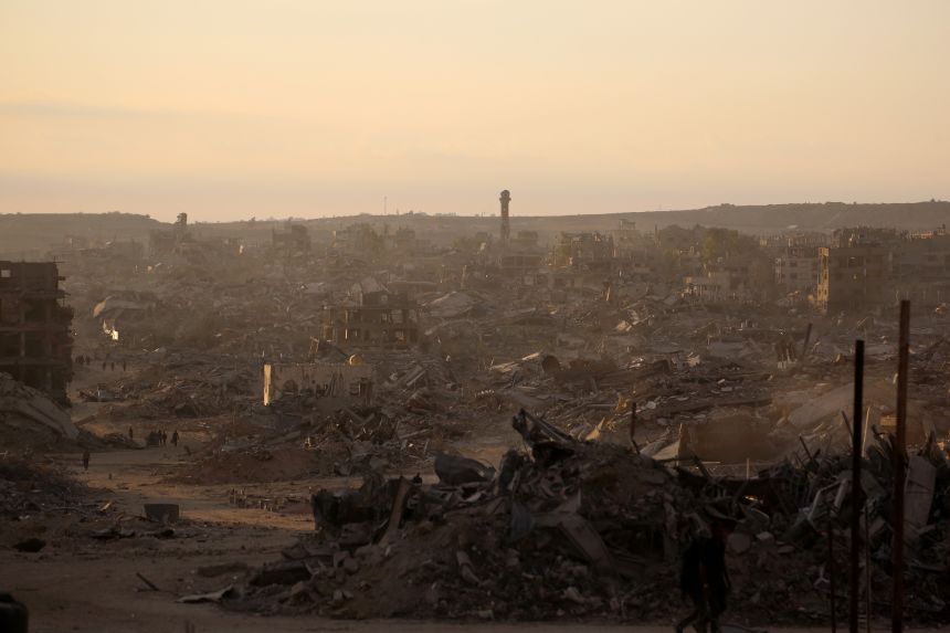A general view shows destroyed buildings as the sun rises in Gaza City on October 12, 2025.
