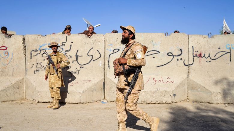 Armed Taliban security personnel keep guard near the closed gate of the zero point border crossing between Afghanistan and Pakistan at Spin Boldak district in Kandahar province on October 12, 2025.