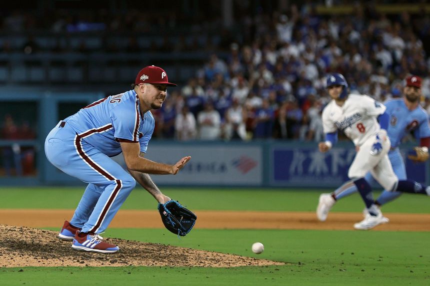 Orion Kerkering attempts to field a ground ball hit by Andy Pages in the 11th inning.