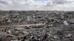 Palestinians walk through the ruins of destroyed buildings in the Al-Nafaq neighborhood of Gaza City on Sunday, after a cease-fire took effect and Israeli forces withdrew from parts of Gaza.
