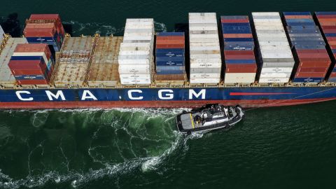 A container ship is assisted by a tugboat as it arrives at the Port of Oakland in California, on October 10.