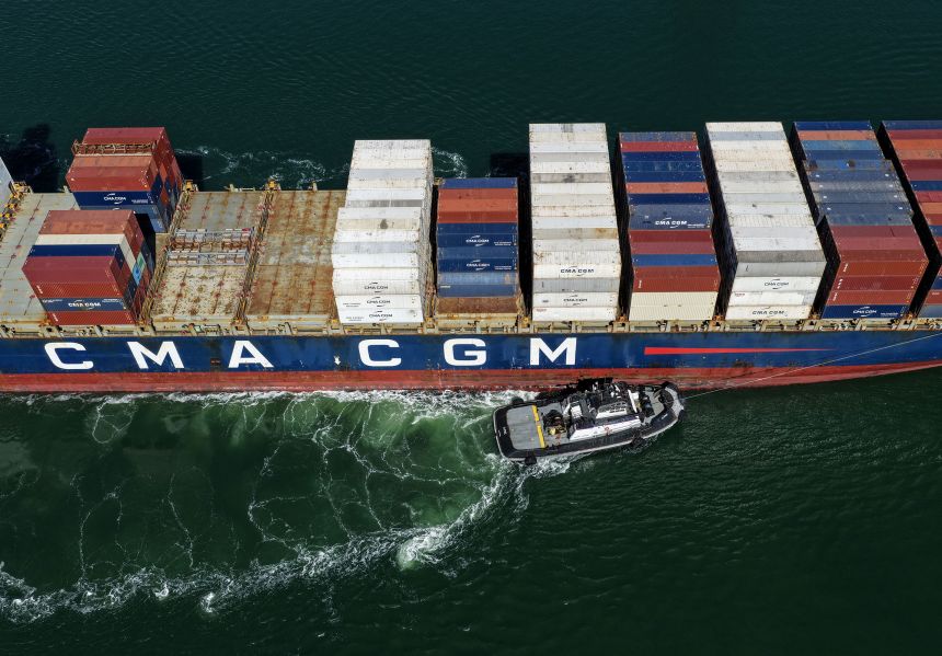 A container ship is assisted by a tugboat as it arrives at the Port of Oakland in California on October 10.