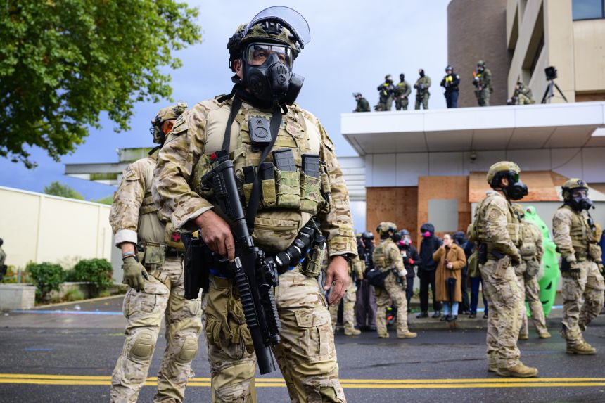 Federal agents clash with anti-ICE protesters at the US Immigration and Customs Enforcement building in Portland, Oregon, on October 12.