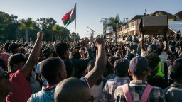 Residents and protesters cheer and hold banners as they gather for a civil society rally outside City Hall in Antananarivo, on October 13, 2025. Soldiers and security forces joined hundreds celebrating in Madagascar's capital on October 13, 2025, hours before President Andry Rajoelina was due to address the nation following weeks of protests and growing calls for his resignation. (Photo by RIJASOLO / AFP) (Photo by RIJASOLO/AFP via Getty Images)          