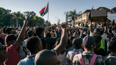 Residents and protesters cheer and hold banners as they gather for a civil society rally outside City Hall in Antananarivo, on October 13, 2025. Soldiers and security forces joined hundreds celebrating in Madagascar's capital on October 13, 2025, hours before President Andry Rajoelina was due to address the nation following weeks of protests and growing calls for his resignation. (Photo by RIJASOLO / AFP) (Photo by RIJASOLO/AFP via Getty Images)          
