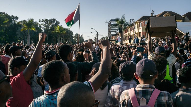 Residents and protesters cheer and hold banners as they gather for a civil society rally outside City Hall in Antananarivo, on October 13, 2025. Soldiers and security forces joined hundreds celebrating in Madagascar's capital on October 13, 2025, hours before President Andry Rajoelina was due to address the nation following weeks of protests and growing calls for his resignation. (Photo by RIJASOLO / AFP) (Photo by RIJASOLO/AFP via Getty Images)          