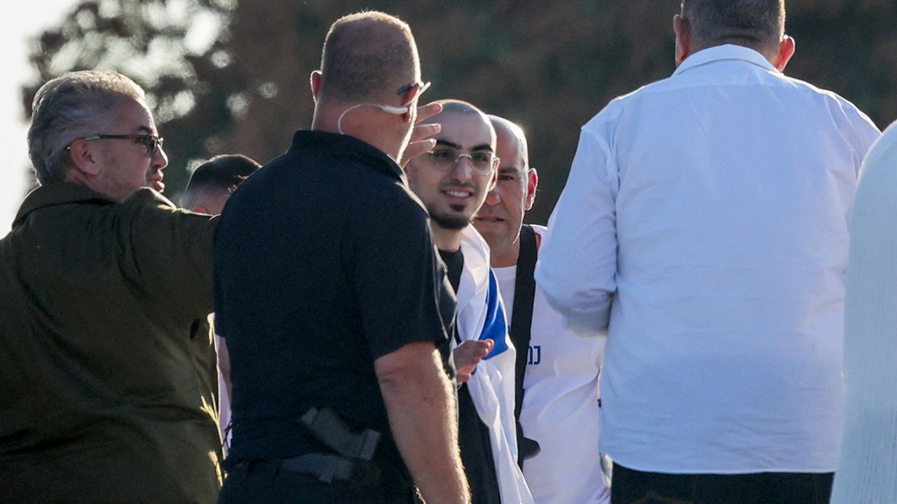 Israeli soldiers accompany Rom Braslavski, formerly held hostage in Gaza since October 2023 by Palestinian militants, upon his arrival at the Sheba Tel-HaShomer Medical Centre in Ramat Gan on October 13, 2025. (Photo by Ahmad GHARABLI / AFP) (Photo by AHMAD GHARABLI/AFP via Getty Images)