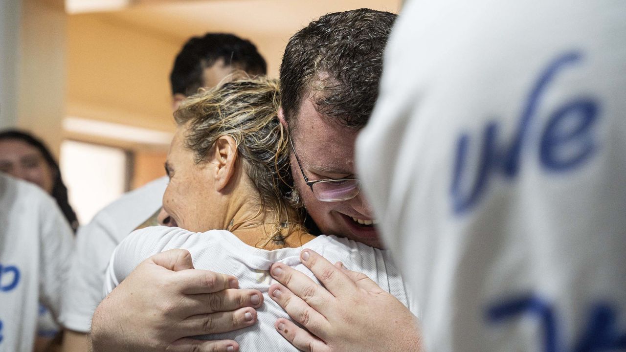 Two family members hug each other while waiting at Hostages Square in Tel Aviv, Israel, on October 13, 2025, as relatives and friends gather to watch the live broadcast of hostage Guy Gilboa Dalal's release and reunion with his family. (Photo by Ori Aviram / Middle East Images via AFP) (Photo by ORI AVIRAM/Middle East Images/AFP via Getty Images)