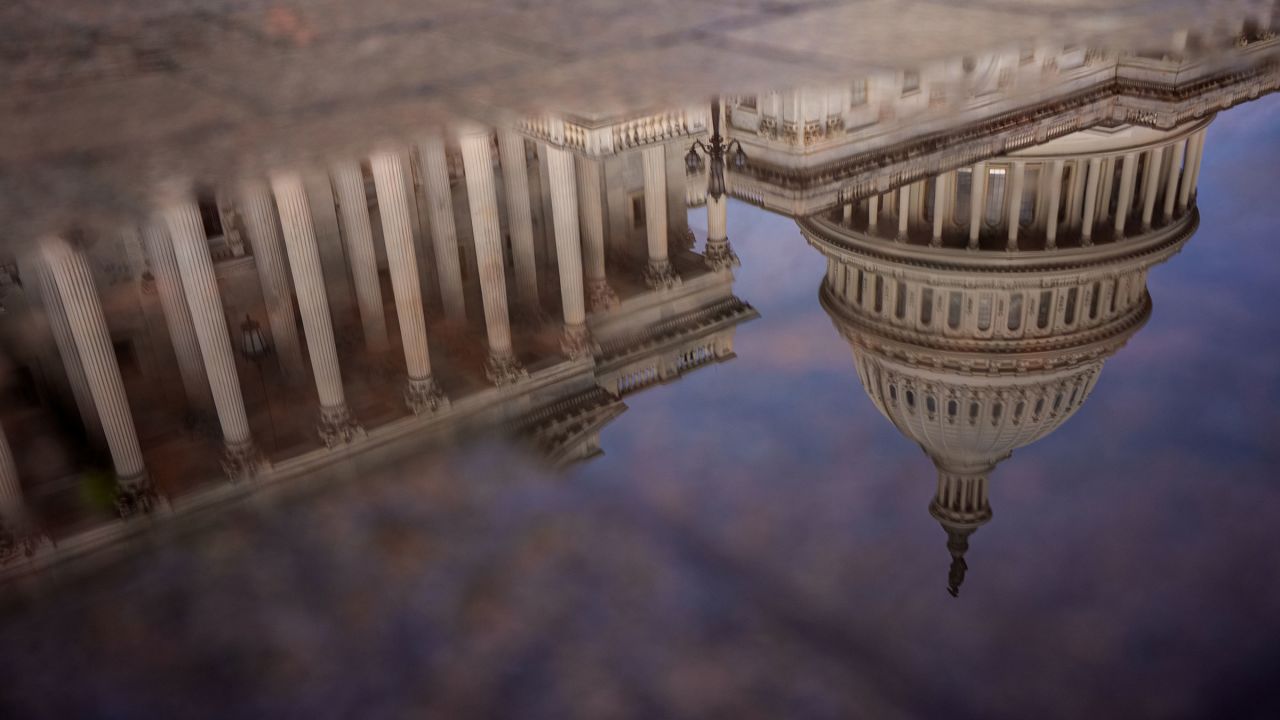 WASHINGTON, DC - OCTOBER 14: The Dome of the U.S. Capitol Building is visible in reflection on October 14, 2025 in Washington, DC. The government remains shut down after Congress failed to reach a funding deal 14 days ago. (Photo by Andrew Harnik/Getty Images)