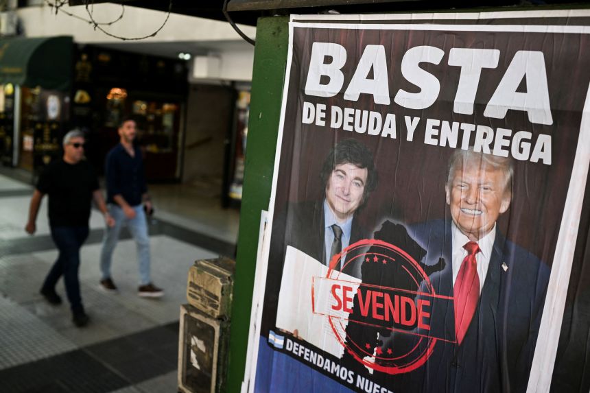 A poster featuring Argentina's President Javier Milei and US President Donald Trump reads "No More Debt and Surrender," in Buenos Aires on Tuesday.