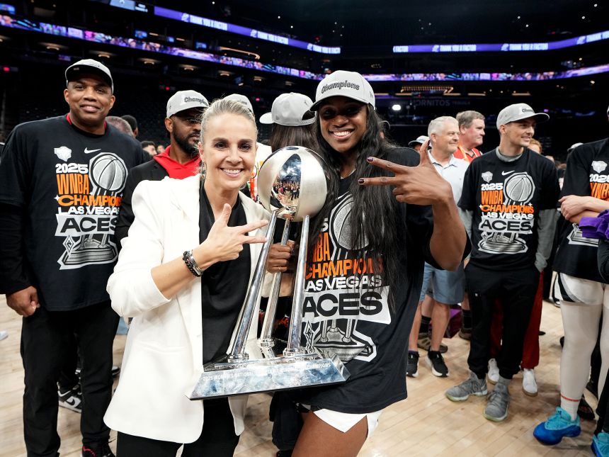 Hammon poses for a photo with the 2025 WNBA Championship trophy.