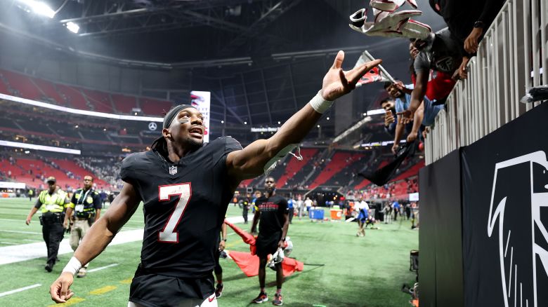 Bijan Robinson #7 of the Atlanta Falcons throws his gloves into the stands after defeating the Buffalo Bills in the game at Mercedes-Benz Stadium in Atlanta, Georgia on October 13, 2025.