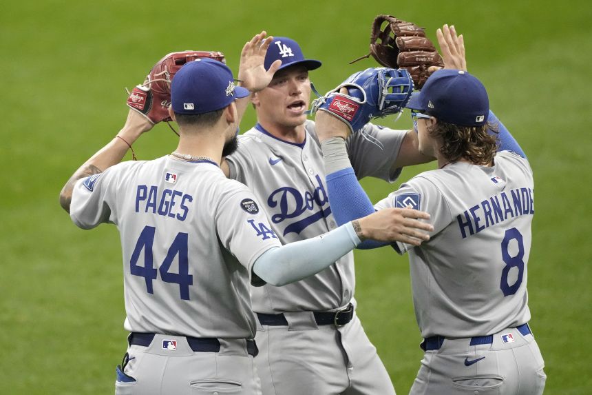 Dodgers players celebrate after beating the Milwaukee Brewers 2-1 in Game 1 of the NLDS.