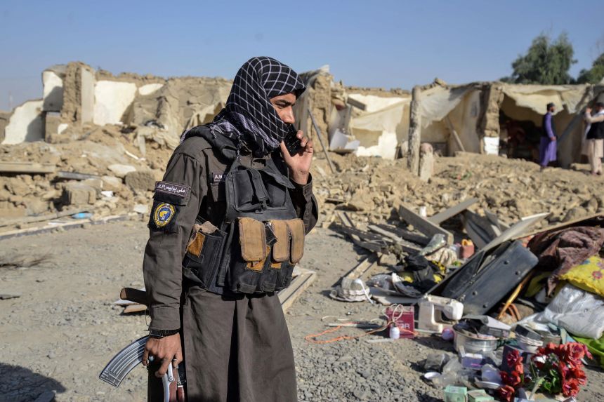 A Taliban security personnel stands near a damaged house in the Spin Boldak district of Kandahar province on October 16, 2025, a day after the cross-border clashes between Afghanistan and Pakistan.