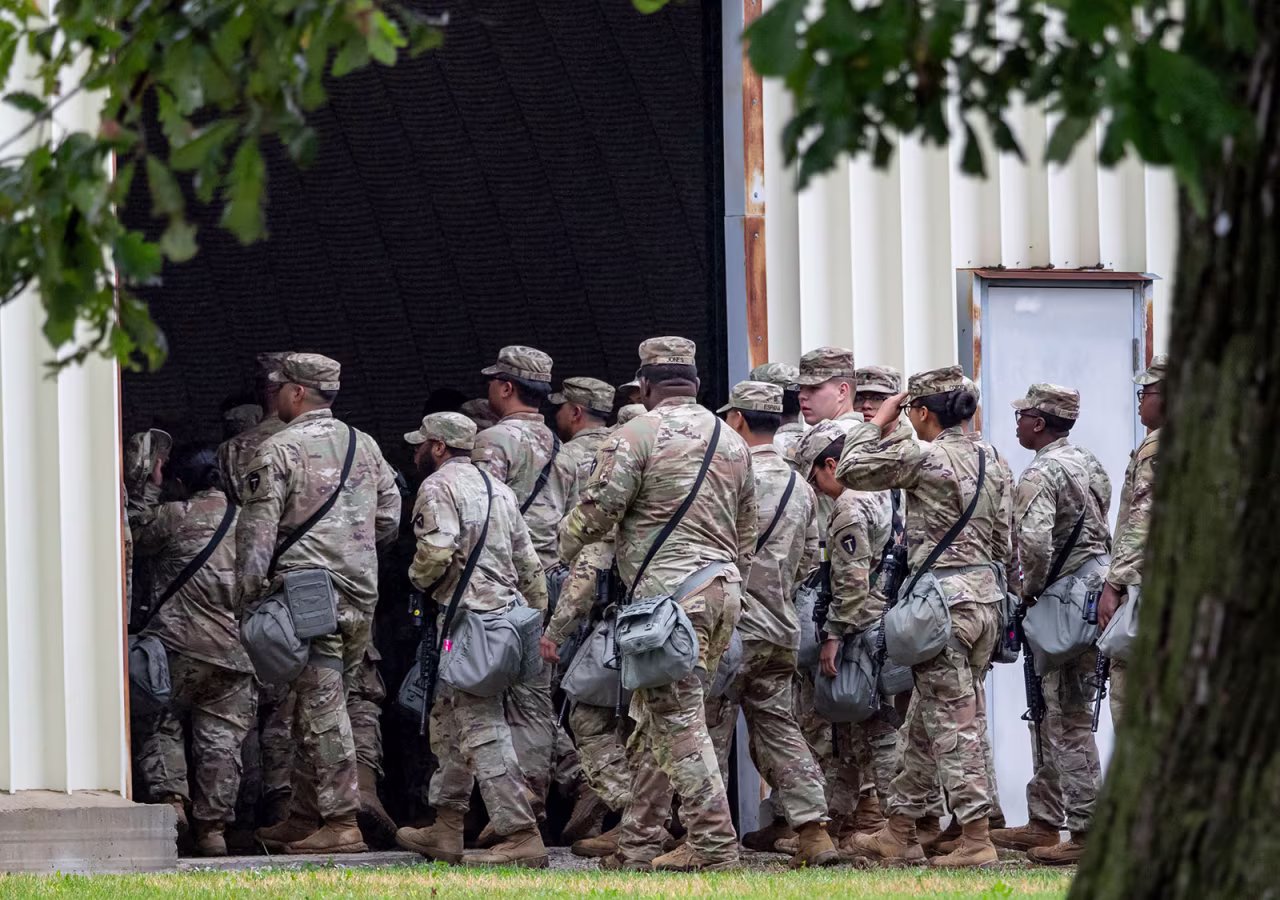 Members of the Texas National Guard arrive on October 7 at the Army Reserve Training Center in Elwood, Illinois.