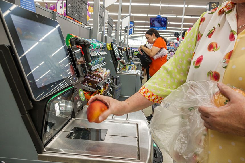 Customers use a self checkout lane at a Walmart Supercenter in Floirida on October 10.