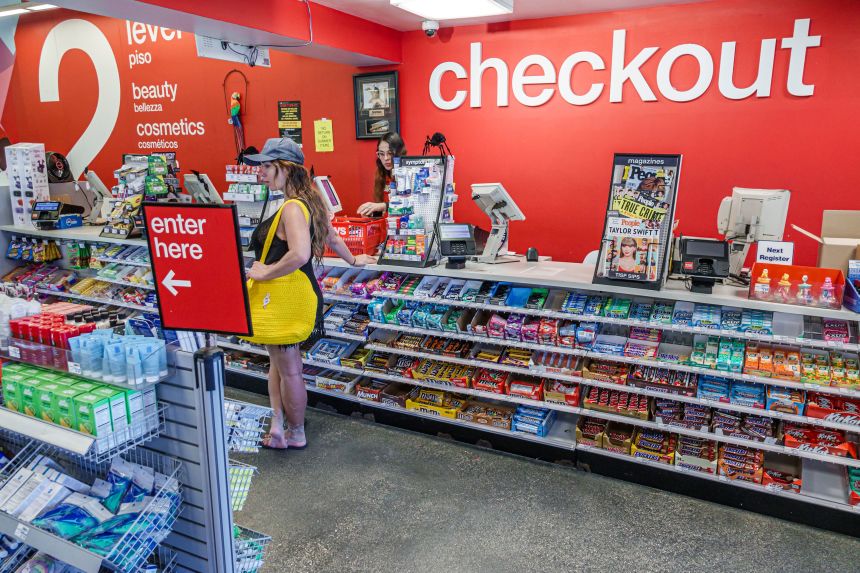 A person makes purchases at a CVS in Miami Beach, Florida.