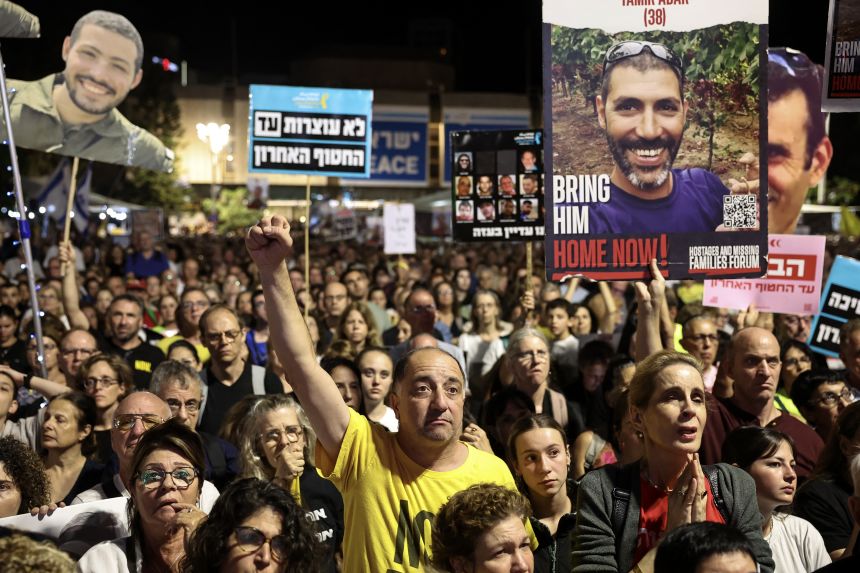 People take part in a demonstration at Hostages Square in Tel Aviv on Saturday, calling for the release of all the bodies of hostages held in Gaza by Palestinian militant group Hamas.