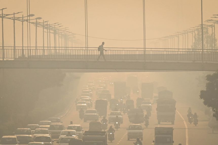 A layer of smog can be seen in the early hours of the morning at Wazirabad, in New Delhi, India, on October 18, 2025.