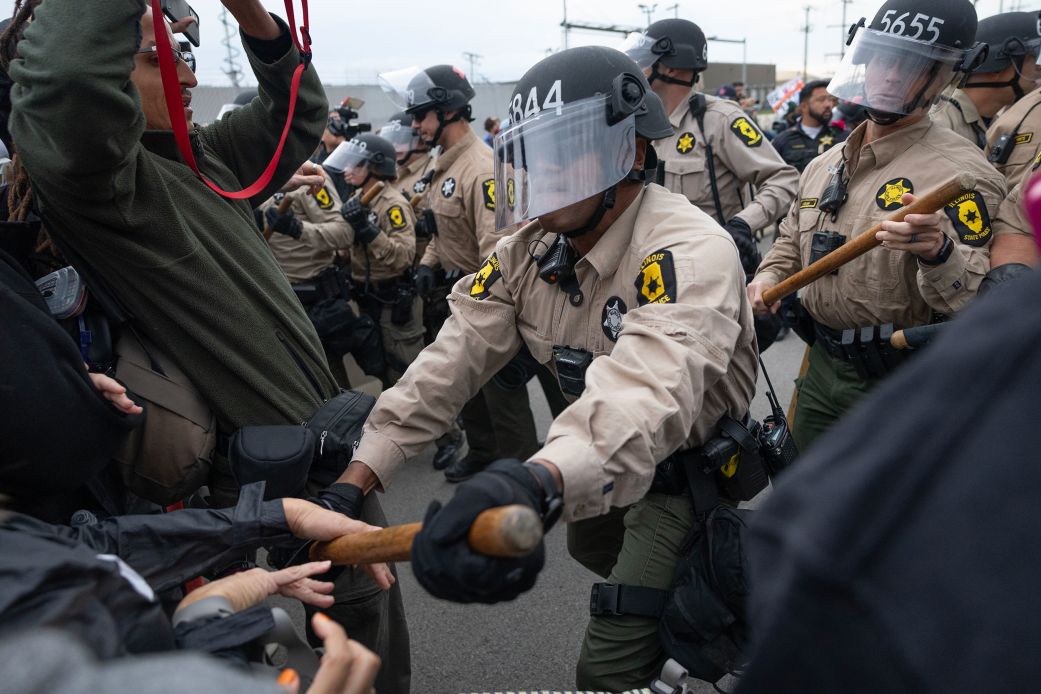 Police clash with demonstrators in the street outside of the "Free Speech Zone" near the immigrant processing and detention center on October 17 in Broadview, Illinois.