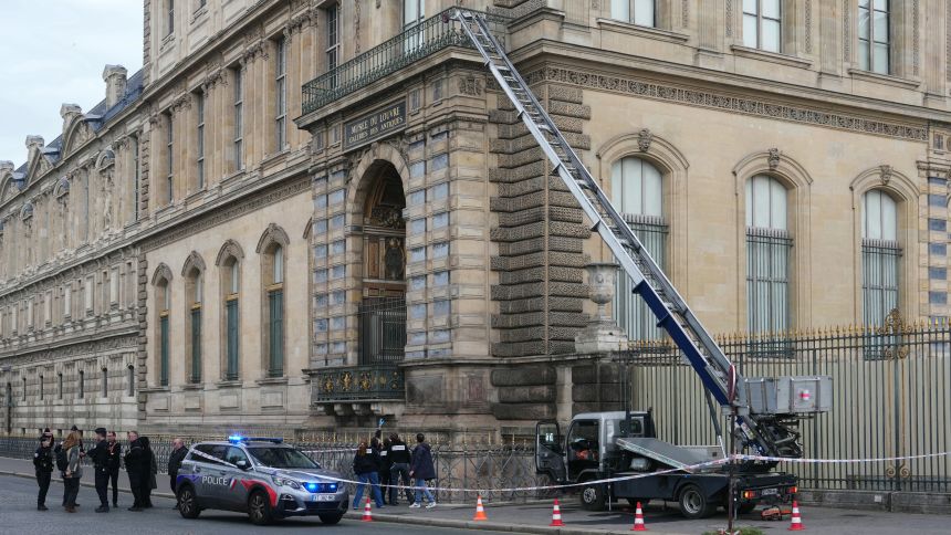 French police officers stand next to a furniture elevator used by robbers to enter the Louvre Museum, on Quai Francois Mitterrand, in Paris, on October 19, 2025.
