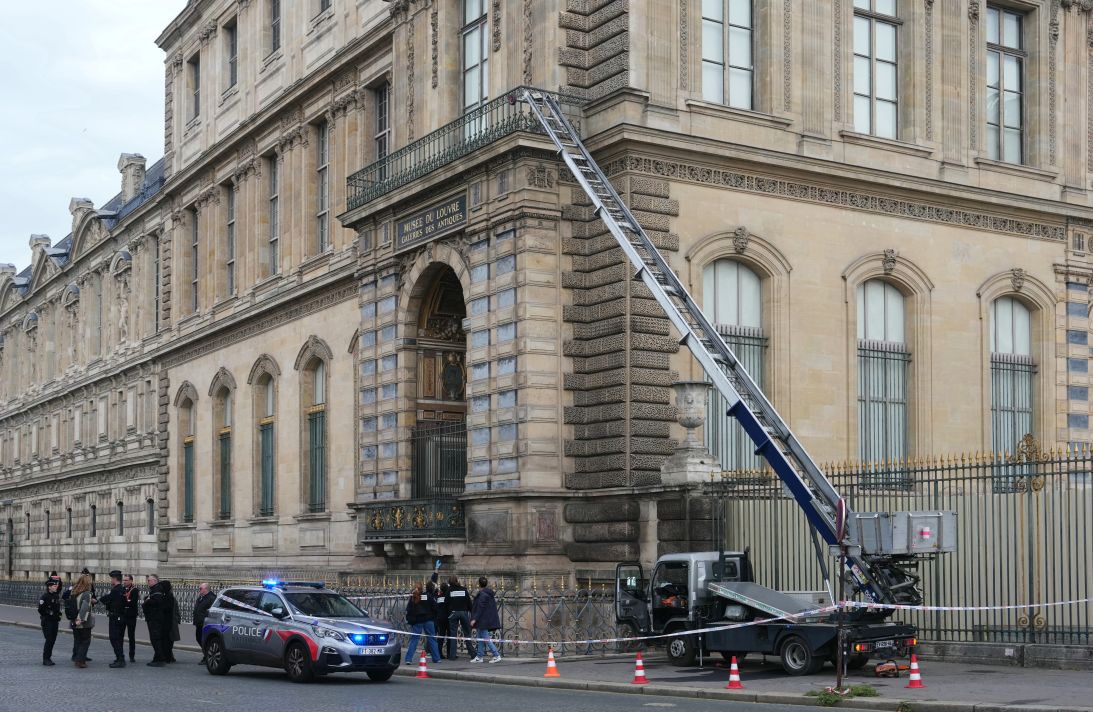 French investigators are seen shortly after the heist, next to a lift truck robbers used to enter the Apollo Gallery. The truck itself had been stolen days earlier.