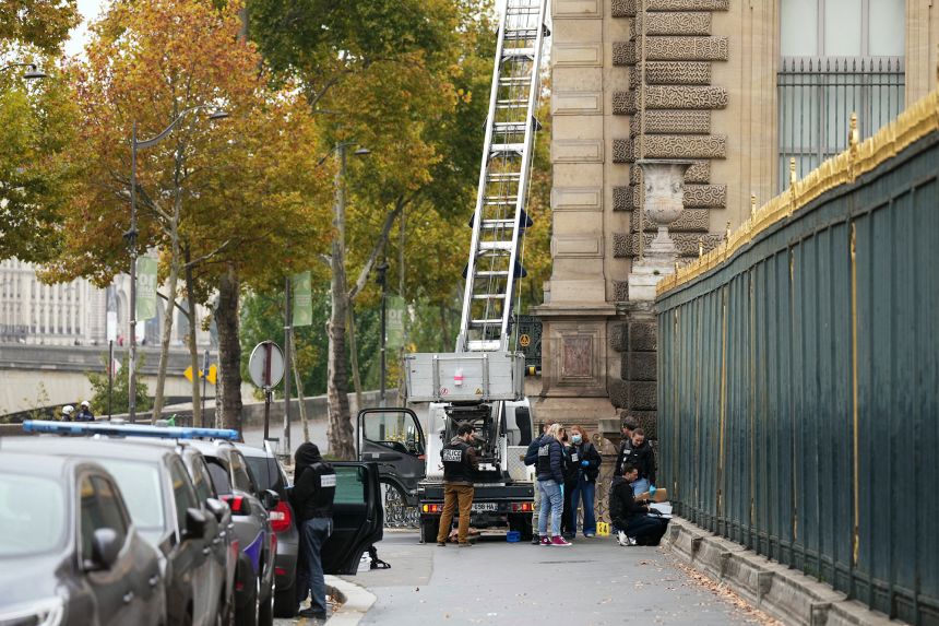 French police officers stand next to a furniture lift used by robbers to enter the Louvre Museum in Paris on October 19, 2025.