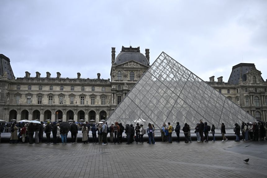 Visitors line up outside the Louvre on Monday, October 20, 2025.
