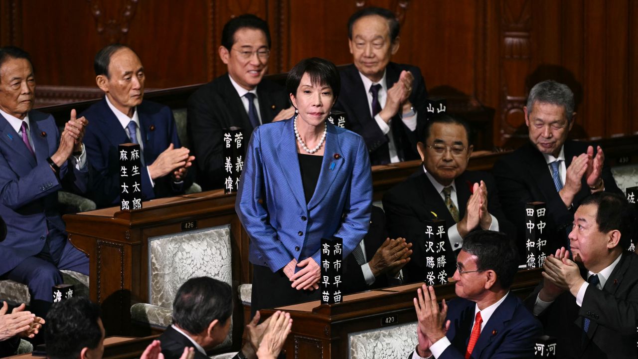 Liberal Democratic Party (LDP) President Sanae Takaichi stands up to acknowledge the applause after she was selected as Japan's new prime minister during an extraordinary session of the lower house of parliament in Tokyo on October 21, 2025.