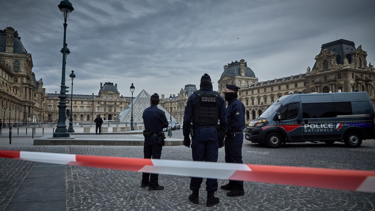 French police officers seal off the entrance to the Louvre Museum after a jewelry theft on Sunday. The interior ministry said the jewels had "inestimable heritage and historical value."
