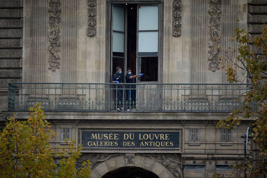 French Crime Scene Officers examine the cut window and balcony of a gallery at the Louvre Museum, the scene of a robbery at the world-famous museum on October 19, 2025, in Paris, France.