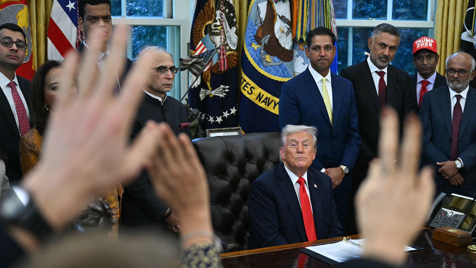 US President Donald Trump takes questions from reporters in the Oval Office of the White House in Washington, DC, on Tuesday, October 21.