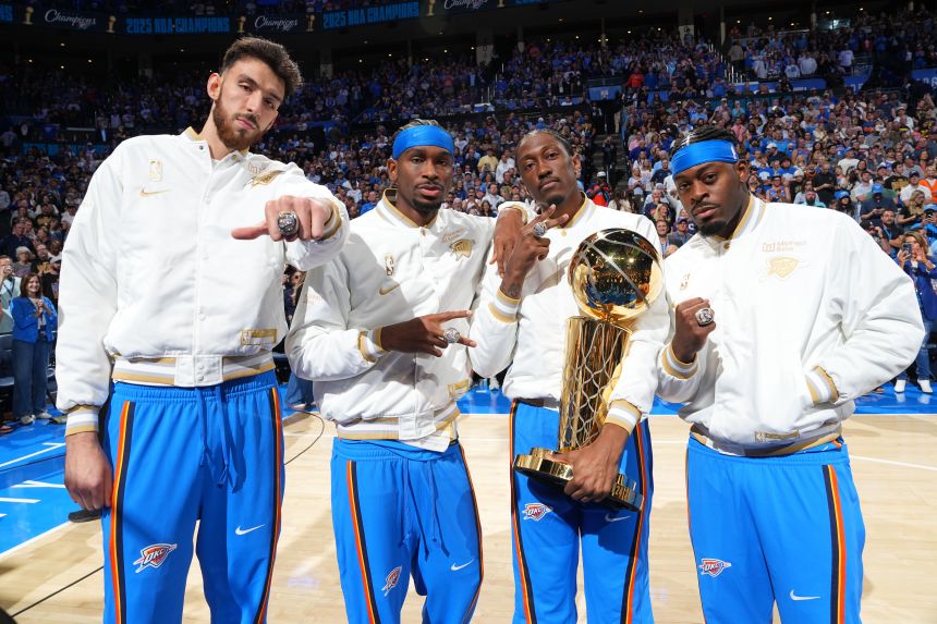 Thunder players celebrated their title victory before the team's season opener on Tuesday.