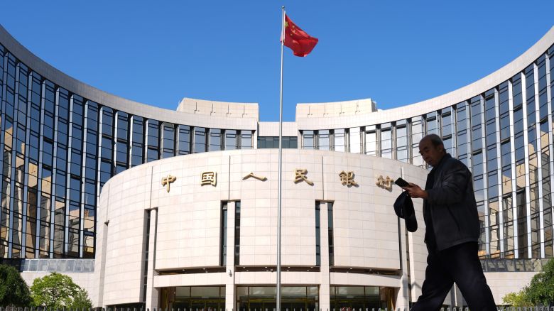 A pedestrian walks past the headquarters of the People's Bank of China in Beijing last month.