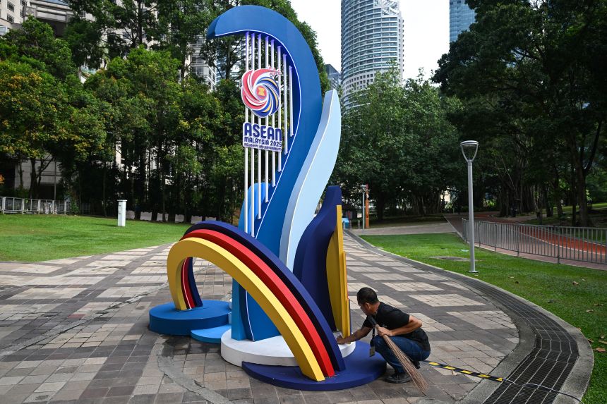 A worker cleans an installation with the logo of the Association of Southeast Asian Nations ahead of the 47th ASEAN Summit in Kuala Lumpur on Saturday.