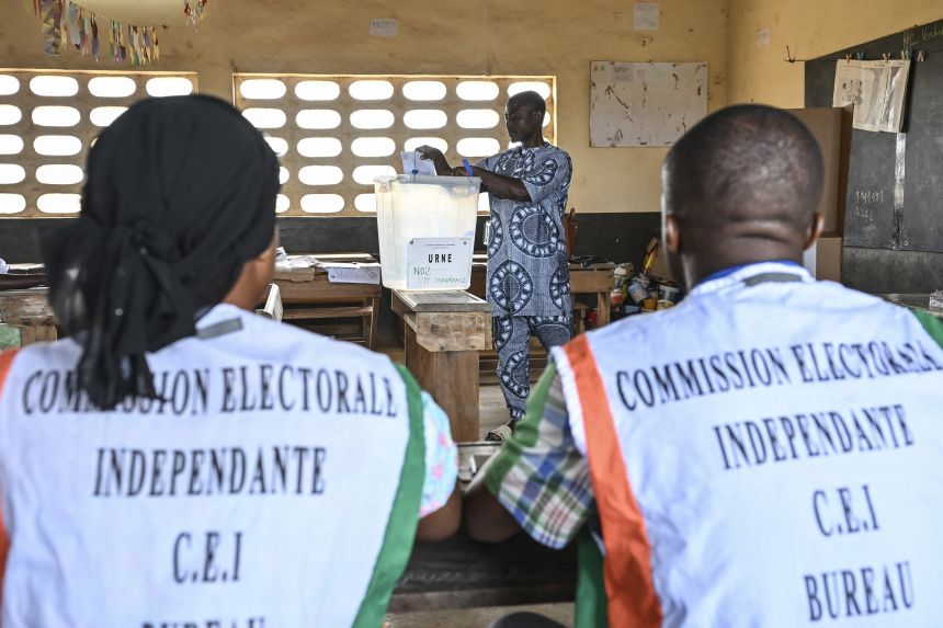 A voter casts his ballot at a polling station in Agboville on Saturday.