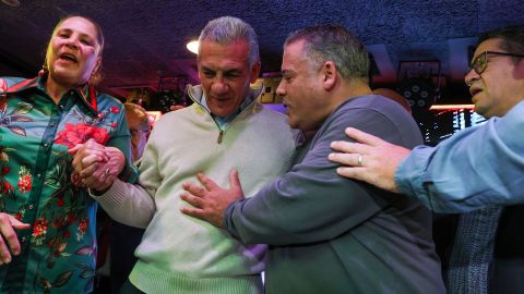 New Jersey Republican gubernatorial candidate Jack Ciattarelli prays with faith leaders while speaking to supporters at a restaurant popular with the Latino community in Paterson, New Jersey, on October 23, 2025.