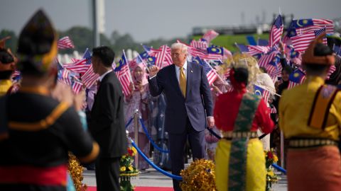 US President Donald Trump acknowledges the crowd as he boards Air Force One at the Kuala Lumpur International Airport on Monday in Kuala Lumpur, Malaysia.