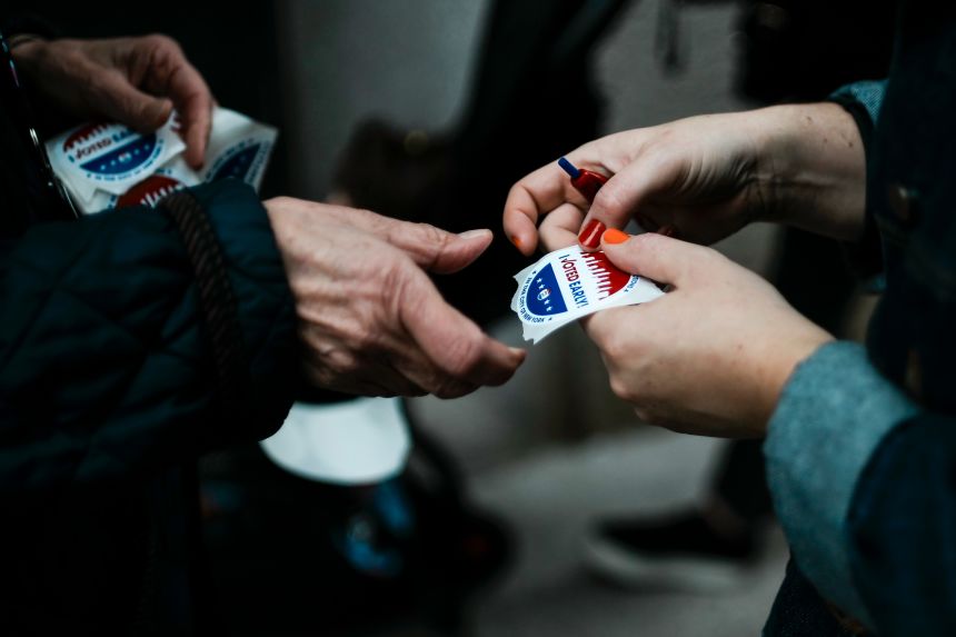 A person receives an I Voted sticker after participating in early voting at a polling site in Manhattan.