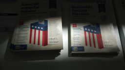 Voter information guides are displayed at a vote center in Los Angeles on October 27, during early in-person voting for the California Proposition 50 special election.