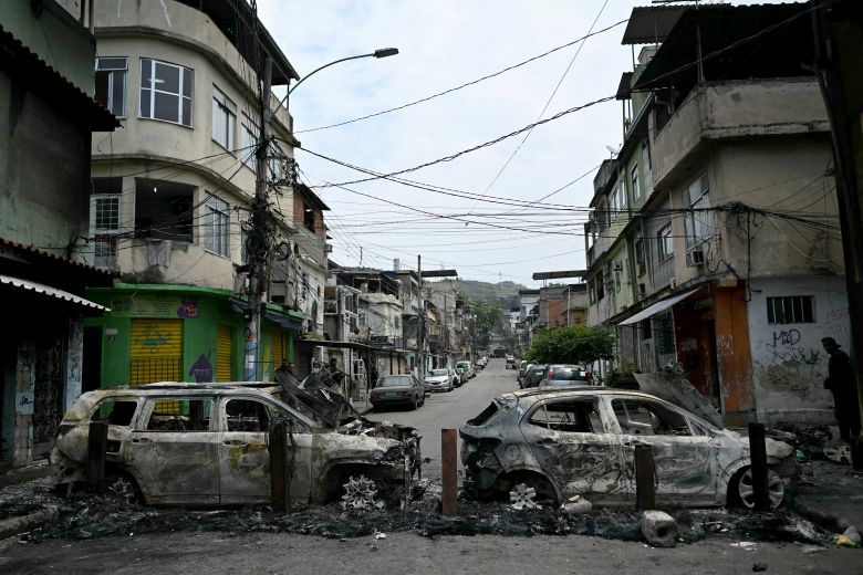 Cars burnt during a barricade within the Operacao Contencao (Operation Containment) at the Vila Cruzeiro favela, in the Penha complex, in Rio de Janeiro, Brazil, on Tuesday.