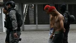 Police officers escort suspects arrested during the Operacao Contencao (Operation Containment) out of the Vila Cruzeiro favela, in the Penha complex, in Rio de Janeiro, Brazil, on October 28, 2025. At least 2,500 agents took part in an operation to arrest drug traffickers from the Comando Vermelho (CV), which resulted in, at least, 18 suspects and several police officers dead. (Photo by Mauro PIMENTEL / AFP) (Photo by MAURO PIMENTEL/AFP via Getty Images)