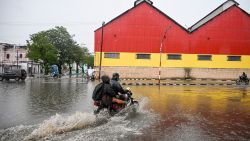 Residents ride motorcycles through flooded areas before Hurricane Melissa hits the city of Santiago de Cuba, Cuba on October 28, 2025.