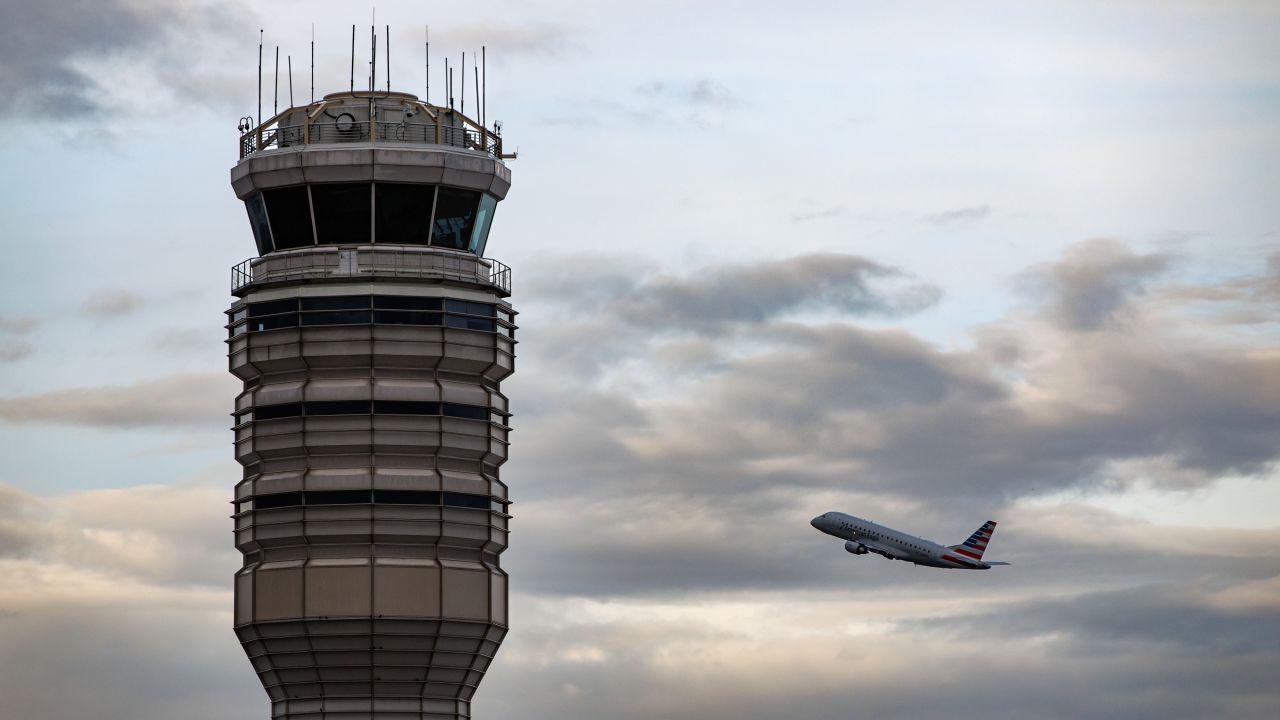 A plane takes off behind the air traffic control tower at Ronald Reagan Washington National Airport in Arlington, Virginia on Tuesday.
