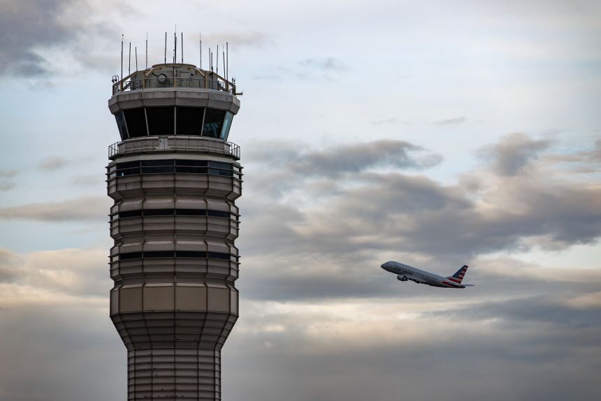 A plane takes off behind the air traffic control tower at Ronald Reagan Washington National Airport in Arlington, Virginia on Tuesday.