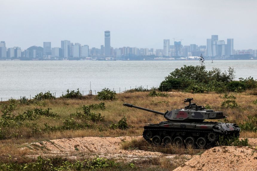 A decommissioned tank is seen outside of the Triangle Fortress in Kinmen, Taiwan, as China's Xiamen city is visible in the background, on October 28, 2025.
